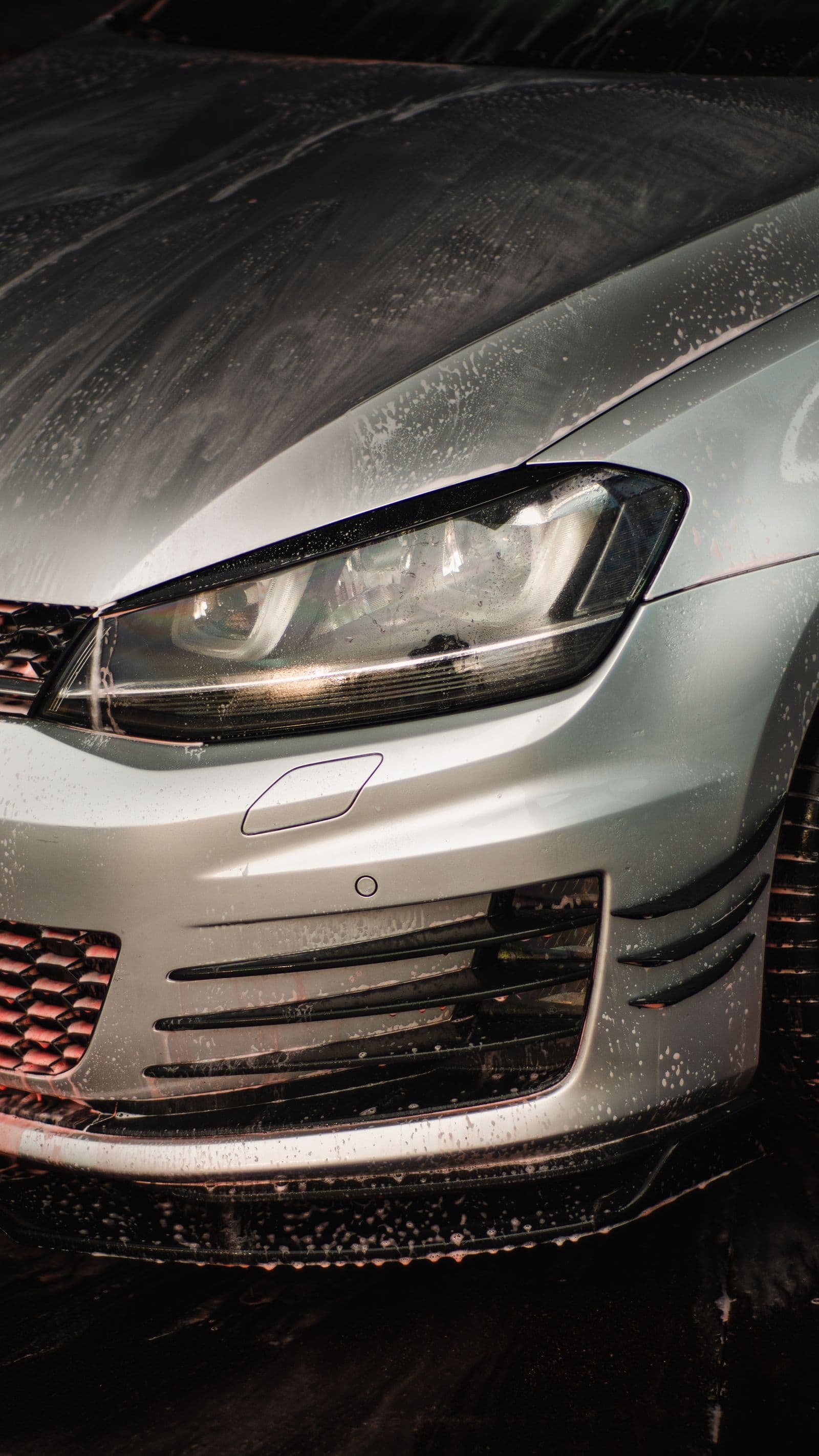 Clean silver hatchback with a mirror-finish headlight and bumper